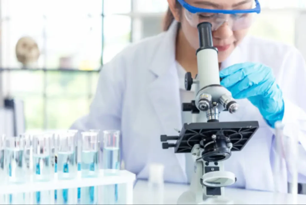 A scientist working with a microscope in a laboratory, representing the pharmaceutical companies and CROs we partner with globally.