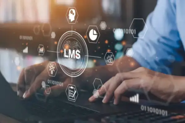 Hands typing on a laptop with a digital LMS icon, representing learning platform localization.